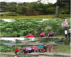 Gotong - royong membersihkan sekitar jalan Keliling Induksi